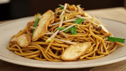 Delicious noodle dish with chicken and sprouts on a plate
