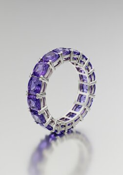 Luxurious eternity band featuring alternating purple amethyst squares and brilliant blue tanzanite ovals set in precious metal ,ring, eternity, jewelry