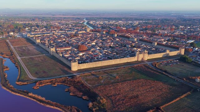 Aerial view of the medieval city of Aigues-Mortes at sunrise, in the Gard department, Occitanie region, France