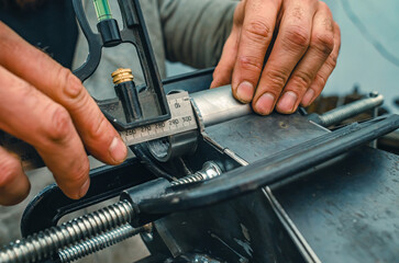 Obraz premium Master measures length of metal in clamp. Preparing metal product for welding. Industrial concept.