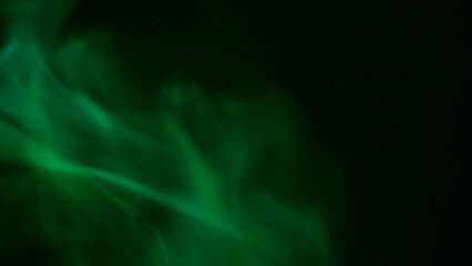 Green Smoke Elegance: Capturing the ethereal dance of vivid green smoke against a black background, evoking a sense of mystery and movement.
