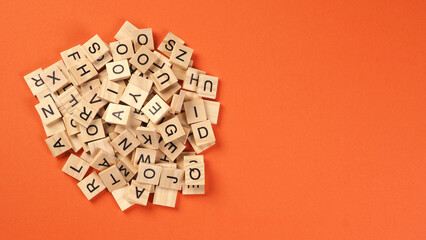 Wooden cube words game isolated on orange background