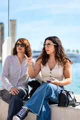 Women looking and pointing at something in the port of Malaga
