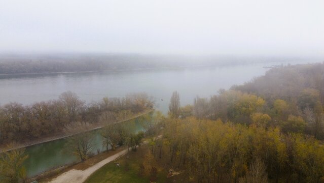 Misty river island with bare autumn trees and calm water
- Powered by Adobe