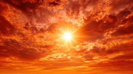Fiery sunset sky with bright sun and crimson clouds nature background