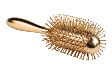 Gold Hair Brush with Metallic Pins isolated on a transparent background