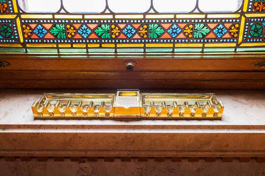 Vintage brass holder for ten cigars set on stained window sill in the 1902 Gothic Revival style Parliament, Budapest, Hungary