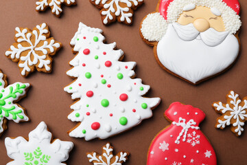 Tasty gingerbread cookies on brown background, flat lay. christmas treat