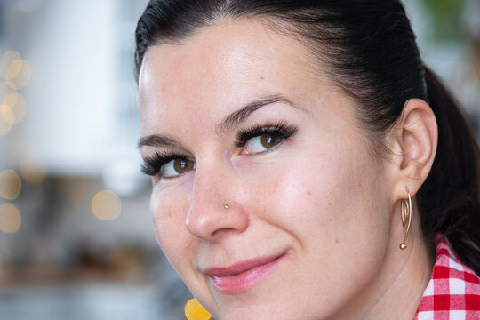 A woman has long extended eyelashes in a close-up with rhinestones. Preparing the image for the holiday