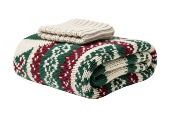 Folded knitted blanket with fair isle pattern and knitted hat cozy winter home decor warm and soft plaid with traditional ornament for cold weather isolated on a transparent background	