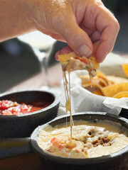 Delicious cheese dip served with crispy tortilla chips on a sunny patio