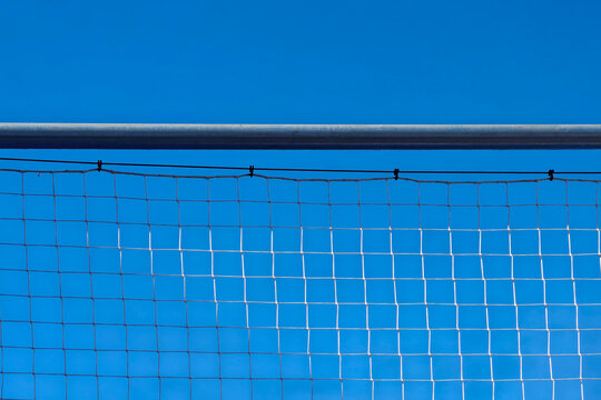 White sports net against clear blue sky