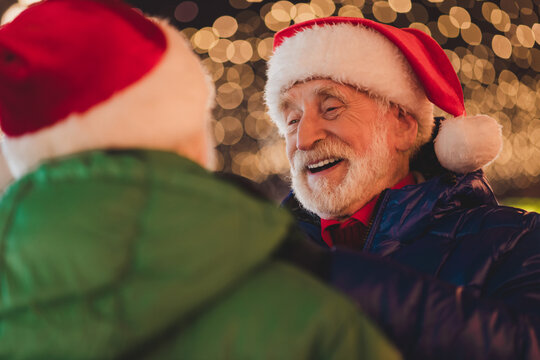 Funny santa moment at a festive outdoor market with grandpa friends sharing warm cheerful holiday joy and laughter