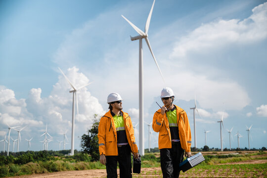 Professional Maintenance Crew Field Inspection Wind Mill Background, Walking Wind Turbine Maintenance Green Power Project. Future Electricity Grid Field Work. Renewable Power Generation Site