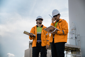 Professional Workers Safety Gear Focusing On Technical Detail, Talking About Small Power Generating Device. Discussing Hybrid Renewable Energy Technology