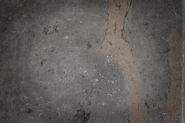 Close-up of unpolished, natural stone or marble texture in gray and taupe with prominent rusty brown vertical veins. Earthy, geological background for architecture or interior design.