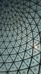 Geometric glass dome with ornamental pattern and sunlight