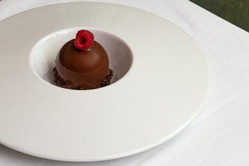 Chocolate Raspberry Sphere Dessert on Restaurant Table