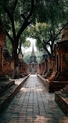 Fototapeta premium An ancient temple ruin in Thailand featuring a large stupa rising prominently in the scene. Weathered brick structures, aged stone textures, and surrounding greenery create a historic vibes