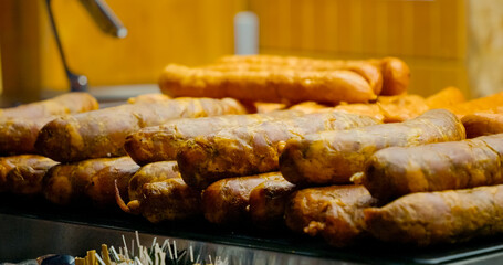 Grilled sausages releasing enticing aroma, sizzling with golden brown texture and mouthwatering appeal on culinary display