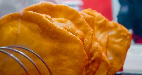 Delicious langosi cooling down after being cooked in oil, ready to be served to customers