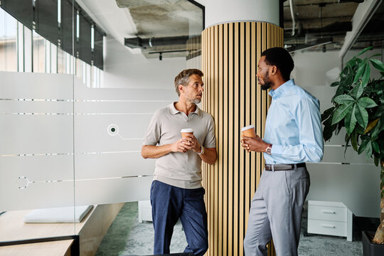 Portrait of two young business man having a meeting or presentation and seminar standing in the office. Portrait of a young businessman talking