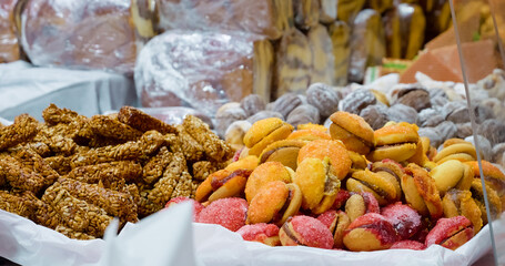 Festive Christmas market stall displaying colorful, traditional sweets and pastries, creating mouthwatering winter holiday atmosphere