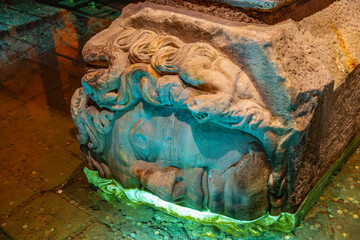 Ancient roman medusa head in basilica cistern with submerged coins