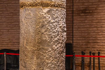 Ancient column with textured surface in historical setting