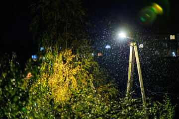 Rain at night illuminated by streetlight