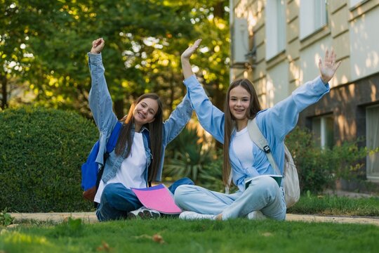 Young happy school children students friends study together