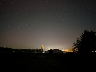 A stunning nightscape of a building under the starlit sky, showcasing the beauty of the cosmos