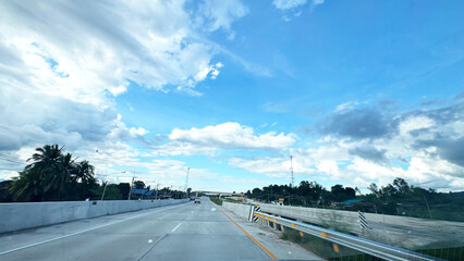 Highway View Under Dramatic Blue Sky with White and Grey Clouds