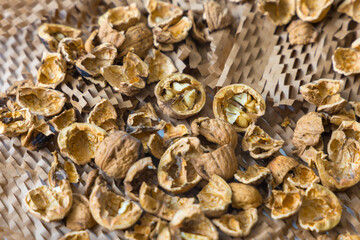 Pile of Cracked Walnut Shells on Honeycomb Packaging Paper