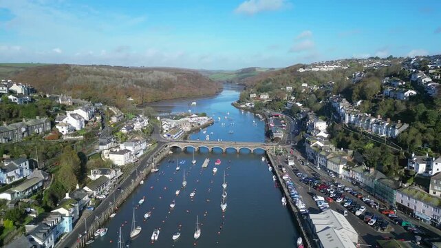 Looe, Cornwall, England: DRONE VIEWS: The drone flies over the course of the East Looe river showing West and East Looe. Looe is an ancient fishing port and popular UK holiday destination (3).