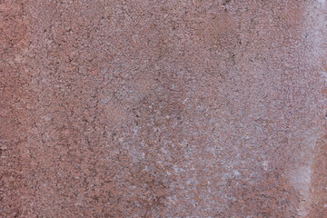 detailed shot of a rustic brownish pink or terracotta colored textured stucco wall for renovation, architecture, and concept of heritage restoration