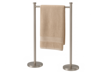 Beige cotton towel hanging on metal towel rack