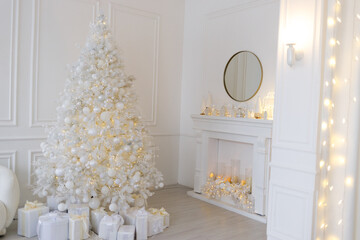 White Christmas interior with decorated tree, glowing garlands, candles, white gifts, elegant festive decor, and a round mirror above a white fireplace.