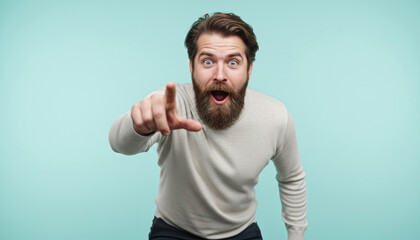 Bearded man surprised and pointing at camera, pastel cyan background, vivid expression.