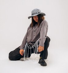 Female hip-hop dancer in gray street style outfit dancing in studio
