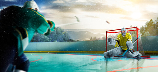 Hockey players in action on the ice. Outdoor game. Sports. Hockey match. A large hockey rink in the middle of an forest. Hockey concept. Panorama