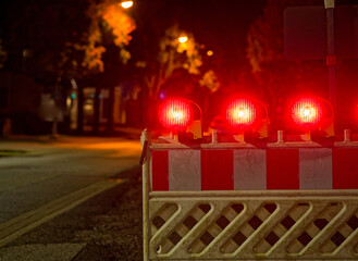 Construction barrier closing road lane with warning reflectors