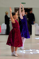 Children dance at a ballroom competition event