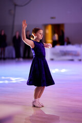 Children compete in ballroom dancing event with grace