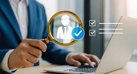 A professional man in a blue suit examines a checkmark on a digital interface while working on a laptop.