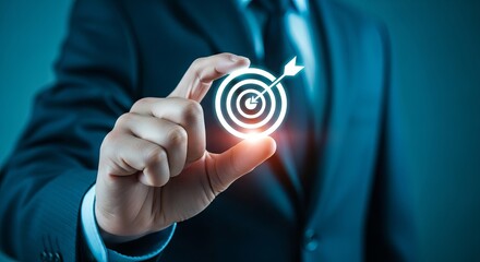 A businessman in a suit holds a glowing target icon, symbolizing focus and success in achieving goals.