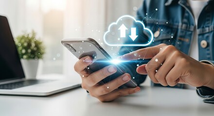 A person using a smartphone to upload data, with cloud storage icons and a laptop in the background.