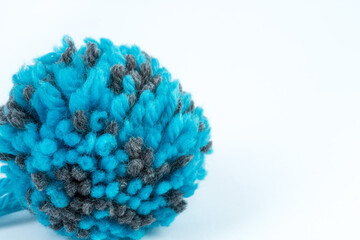 Skein of blue threads for knitting on a white background. pompon. fluffy soft pompon made of yarn.