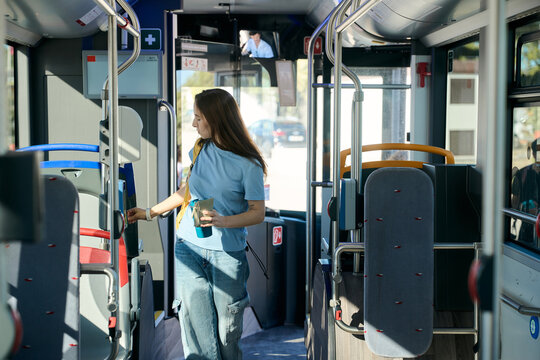 Woman validating ticket on public transport bus