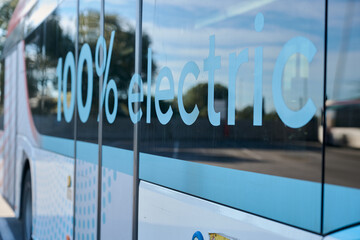 Electric bus displaying 100 percent electric graphic on window
